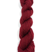 A single skein of deep burgundy yarn, twisted into a ply, shown vertically against a plain white background.