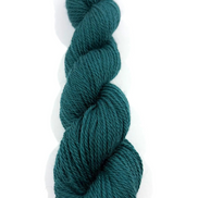 A single skein of dark teal yarn standing vertically on a plain white background.
