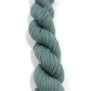 A single skein of twisted yarn in a muted sage green color, photographed vertically against a plain white background.