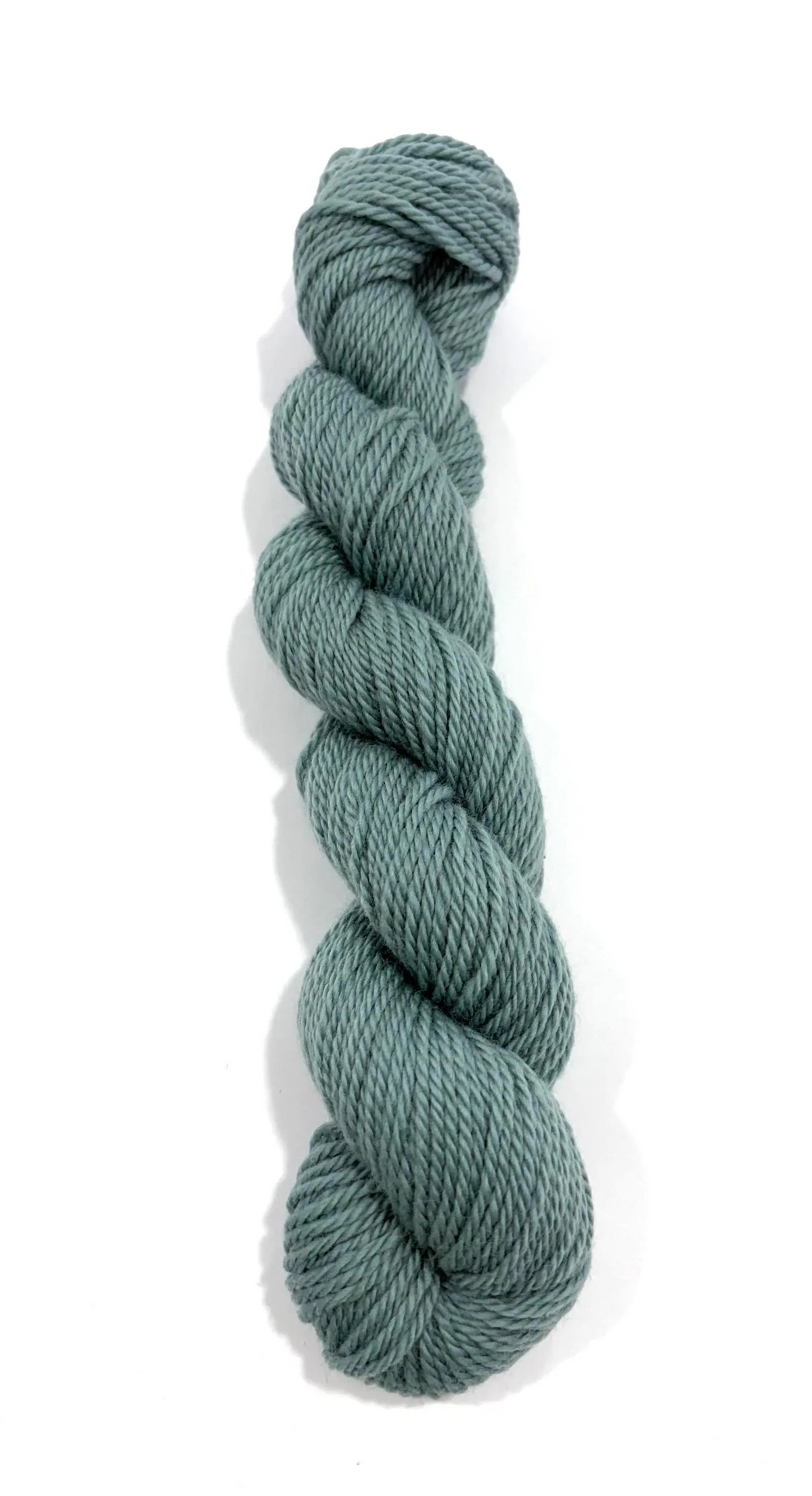 A single skein of twisted yarn in a muted sage green color, photographed vertically against a plain white background.