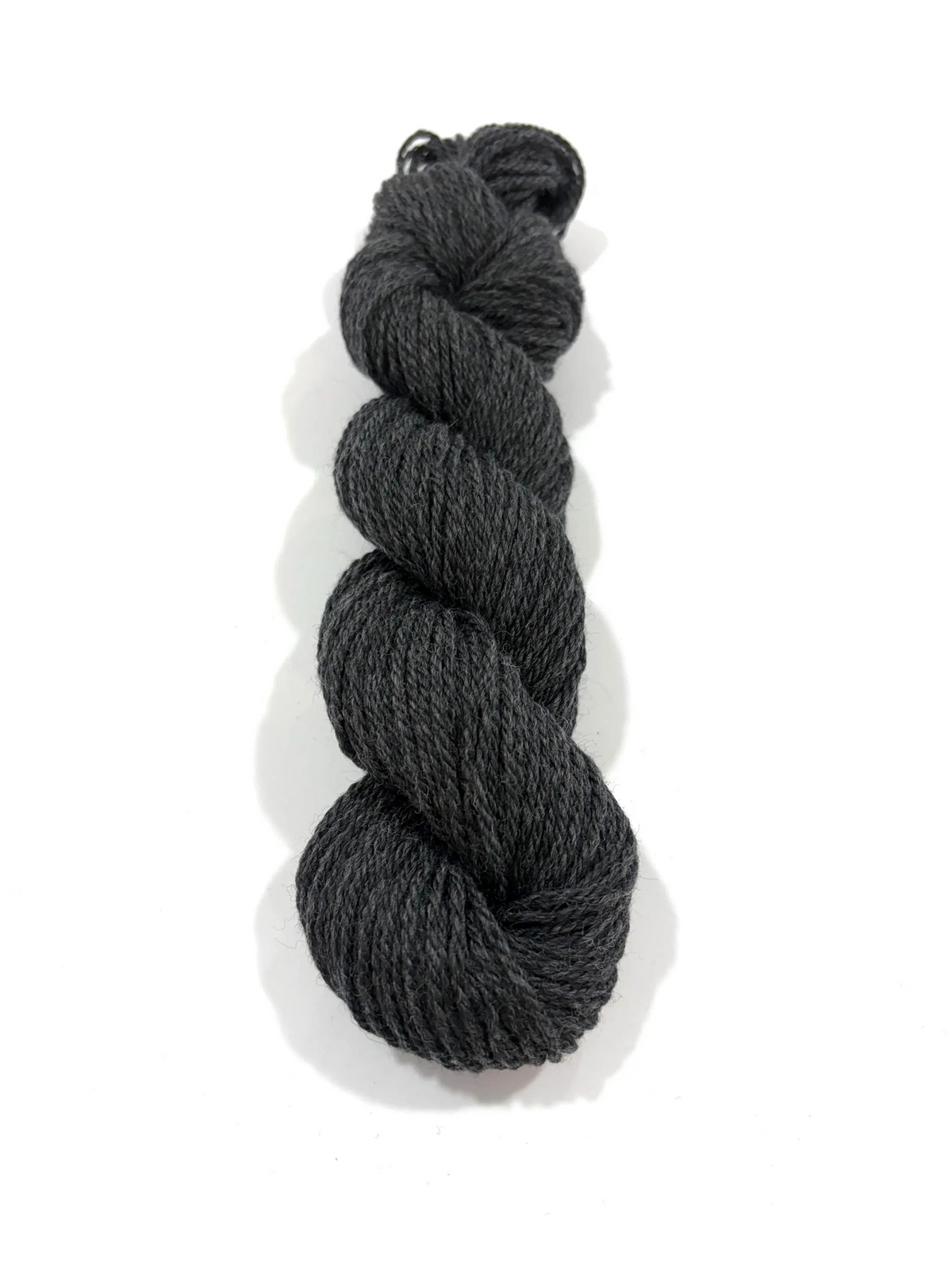 A single skein of dark charcoal gray yarn, twisted into a braid, shown on a clean white background with a soft drop shadow.