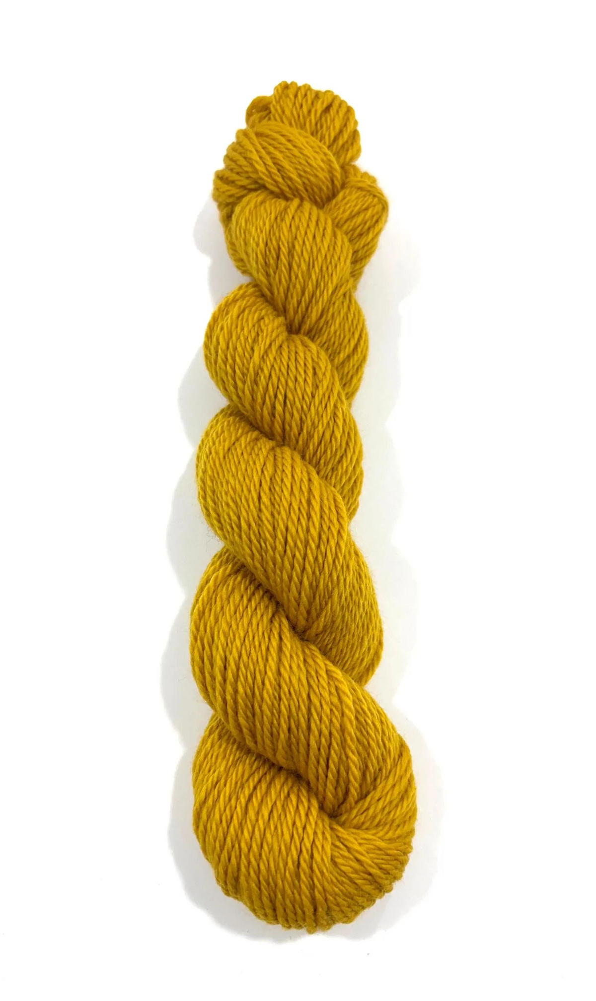 A single skein of twisted yarn in a rich mustard yellow color, photographed vertically against a clean white background.