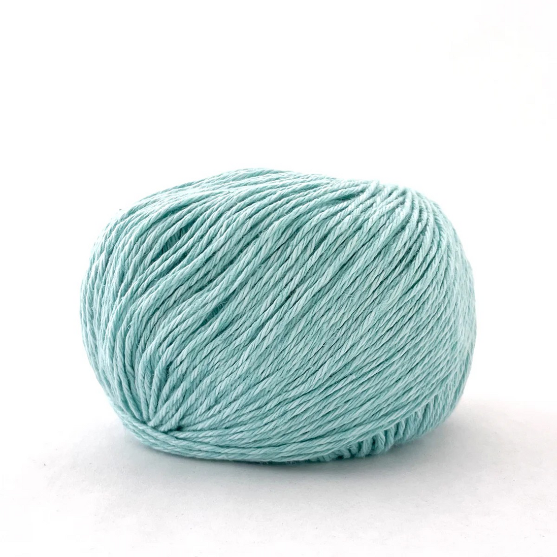 A ball of light mint green yarn on a clean white background.