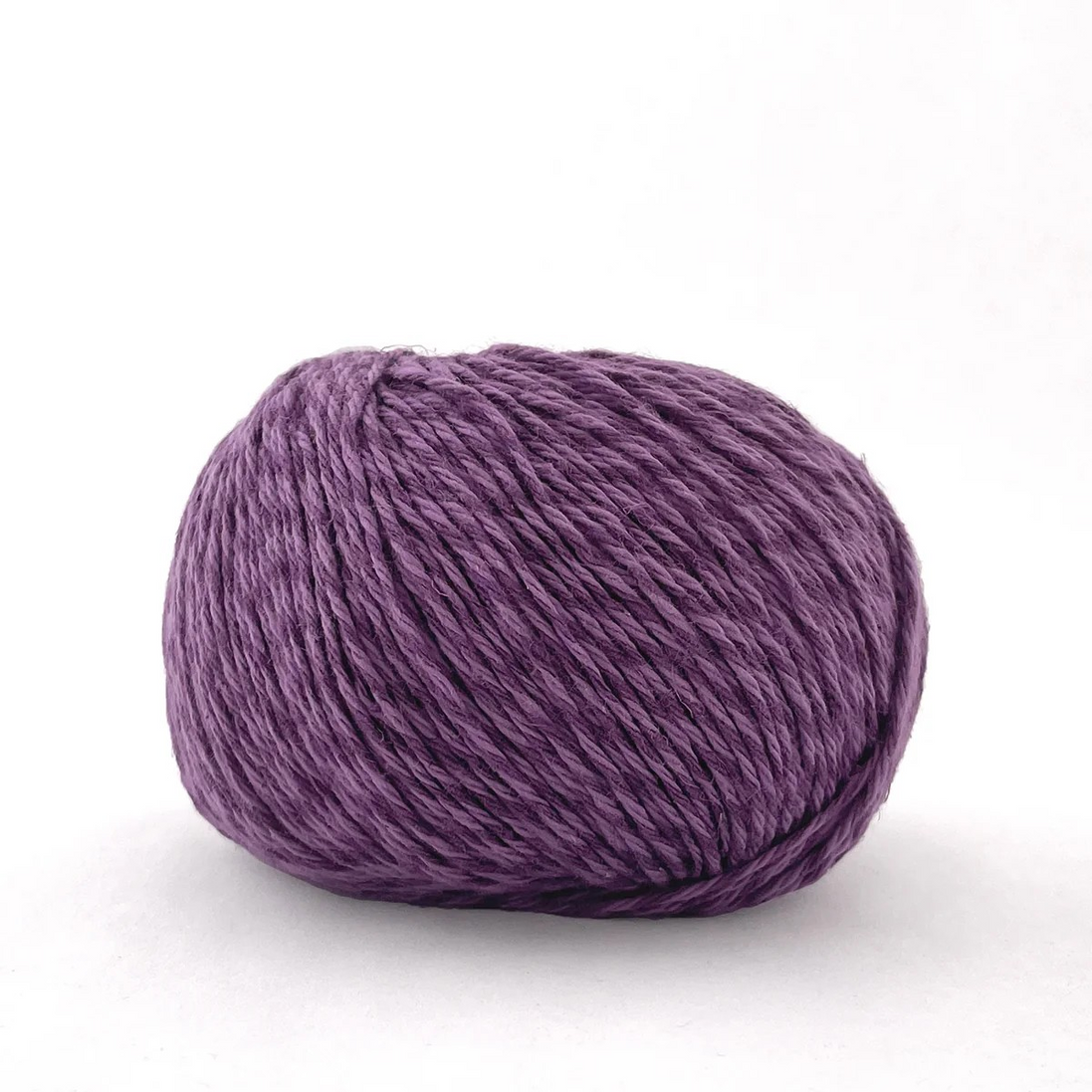 A single ball of textured purple yarn photographed on a clean white background.