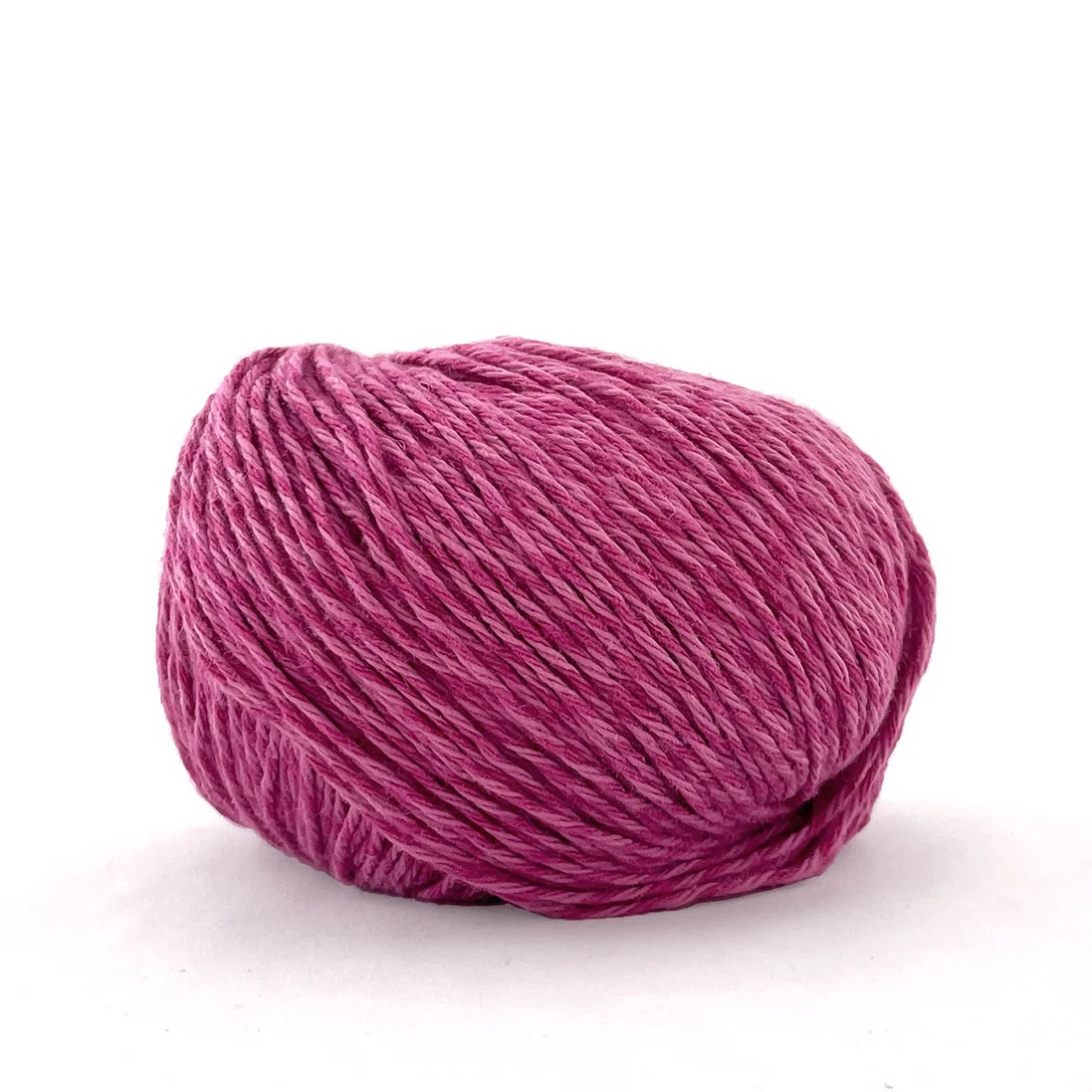 A single ball of variegated magenta-pink yarn on a clean white background.