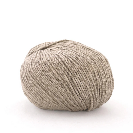 A single ball of light beige yarn photographed on a clean white background.