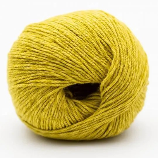 A ball of mustard yellow yarn photographed on a clean white background.