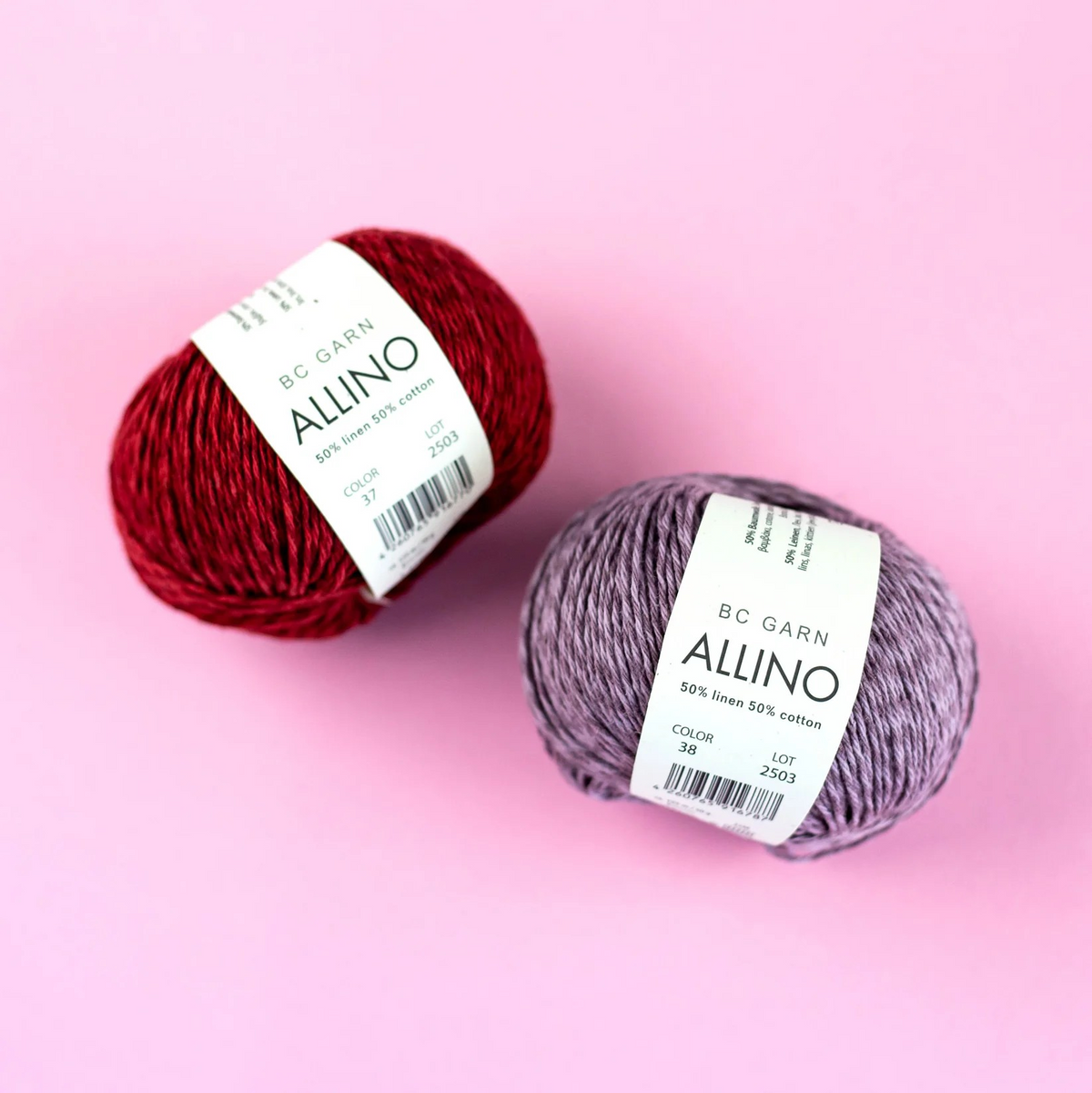 Two balls of yarn, one red and one purple, with BC Garn Allino labels on a pink background.