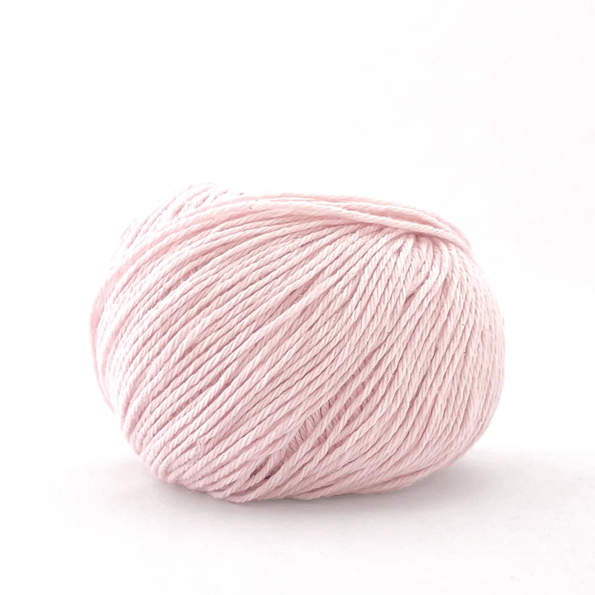 A ball of light pink yarn photographed on a clean white background.
