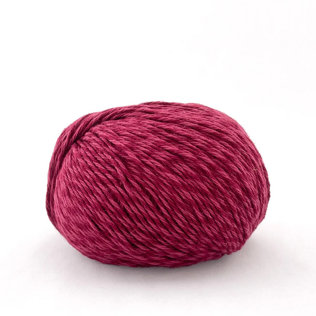 Ball of pink yarn on a white background