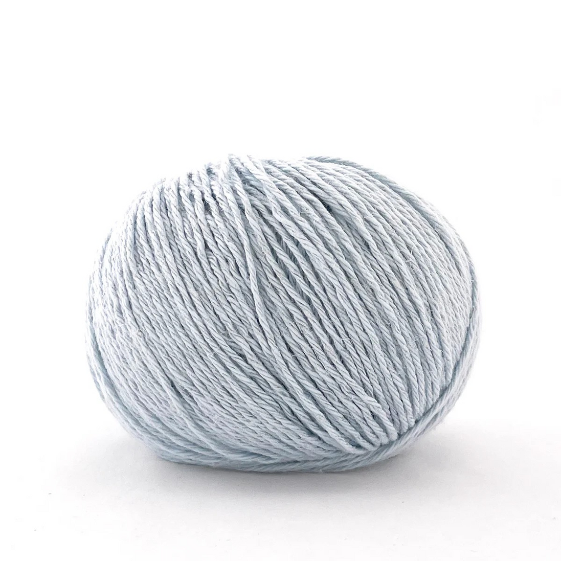 A single ball of light blue-gray yarn photographed on a clean white background.