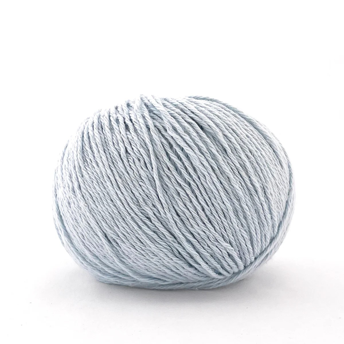 A single ball of light blue-gray yarn photographed on a clean white background.