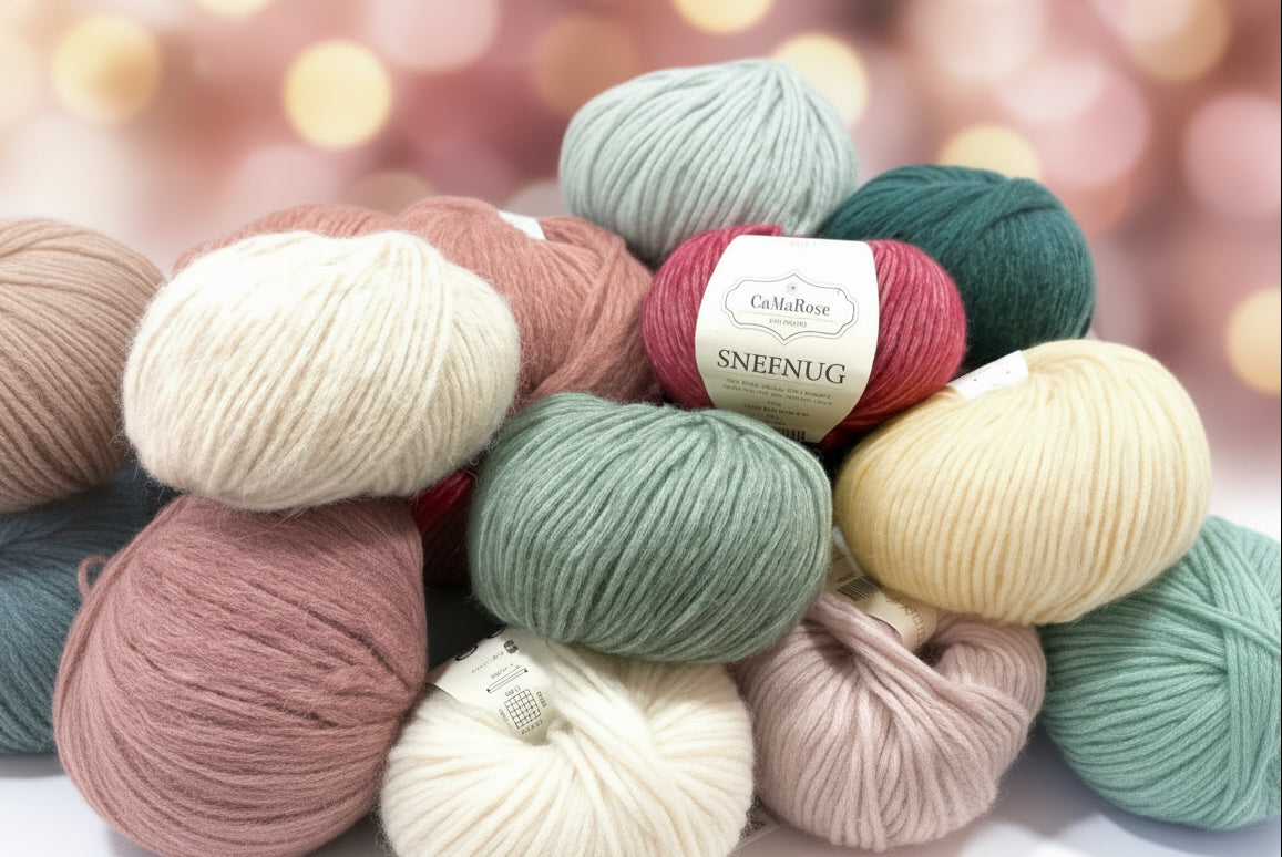 Snefnug By CaMaRose Merino Alpaca Cotton Airy and Plump Yarn Worsted Weight Super Soft Yarn Perfect for Cardigans and Sweaters. A pile of colorful yarn skeins in cream, navy, pink, green, yellow, purple, and light blue, with a central label reading 'CraMaRose SNEFNUG'.