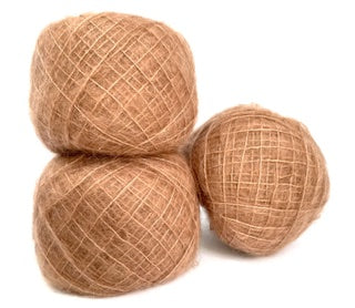 Three balls of natural jute twine in a warm tan-brown color, arranged on a plain white background.