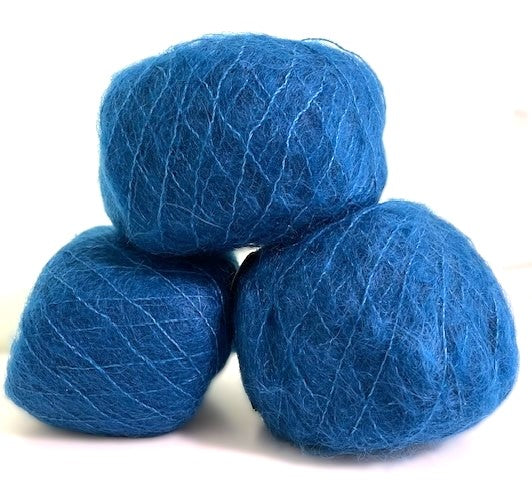 Three balls of vibrant blue yarn stacked together on a plain white background.