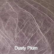 A close-up texture shot of a dusty plum colored pet hair or fur sample, with the text 'Dusty Plum' overlaid at the bottom.