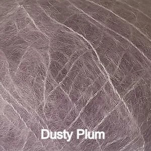 A close-up texture shot of a dusty plum colored pet hair or fur sample, with the text 'Dusty Plum' overlaid at the bottom.