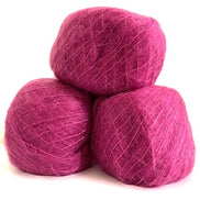 Three balls of magenta pink yarn stacked together on a white background.
