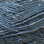Close-up of dark blue-gray yarn with small brown and white flecks throughout, filling the frame.