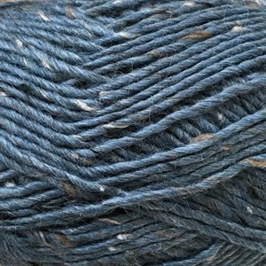Close-up of dark blue-gray yarn with small brown and white flecks throughout, filling the frame.