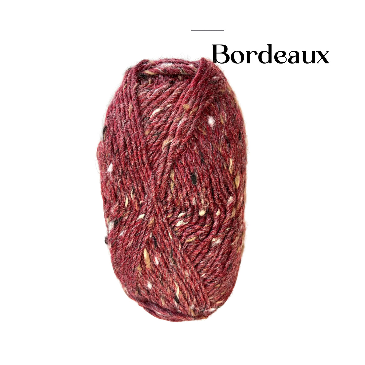 A skein of variegated yarn in a deep burgundy or Bordeaux shade with small cream, black, and tan flecks, shown on a plain white background with the word 'Bordeaux' printed above.