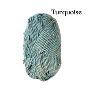 A skein of variegated yarn in a turquoise blue-green color with flecks of beige, black, and brown, shown against a plain white background with the word 'Turquoise' printed in black text in the upper right.