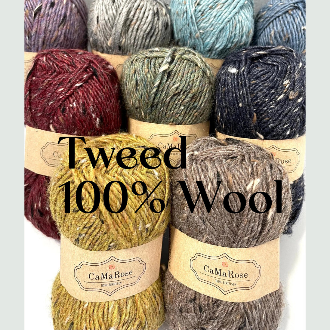 Six skeins of textured tweed wool yarn in various colors, including burgundy, sage green, navy, mustard yellow, taupe, and gray, arranged in two rows. Each skein has a paper label for 'CaMaRose Fine Yarn'.