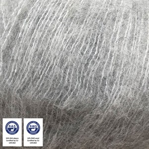 A close-up of light gray to silver-colored curly hair or fiber texture, with two small certification badges in the bottom-left corner.