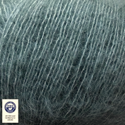 Close-up of blue yarn with RWS label indicating organic cotton.