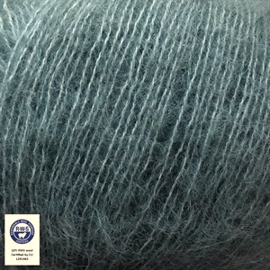 Close-up of blue yarn with RWS label indicating organic cotton.