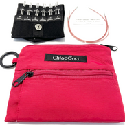 Chiaogoo Mini Knitting Needle Chiaogoo SHORTIE TWIST Red Blue Yellow Mini Knitting Needle Set for Small Circumference Sock Knitting Sleeves Baby Clothes. A bright pink zippered carrying pouch with a black brand label reading 'ChiaoGoo' is shown with included accessories on a white background: a black fabric organizer holding knitting needles, a coil of cable yarn, and a black ring clip.