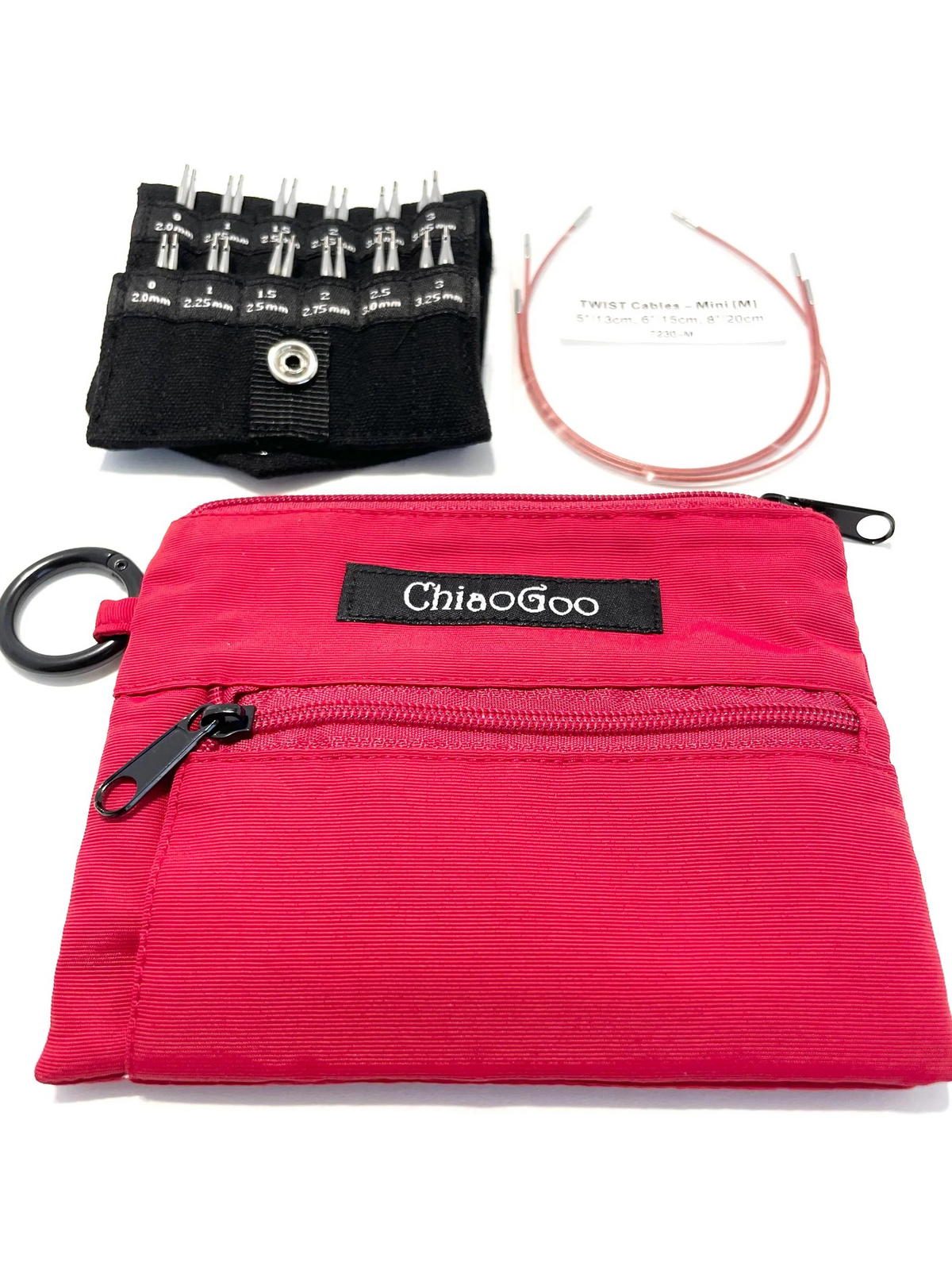 Chiaogoo Mini Knitting Needle Chiaogoo SHORTIE TWIST Red Blue Yellow Mini Knitting Needle Set for Small Circumference Sock Knitting Sleeves Baby Clothes. A bright pink zippered carrying pouch with a black brand label reading 'ChiaoGoo' is shown with included accessories on a white background: a black fabric organizer holding knitting needles, a coil of cable yarn, and a black ring clip.